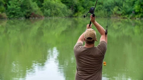 Fisherman is getting ready to throw some fish hook into the water Stock Footage 112176593