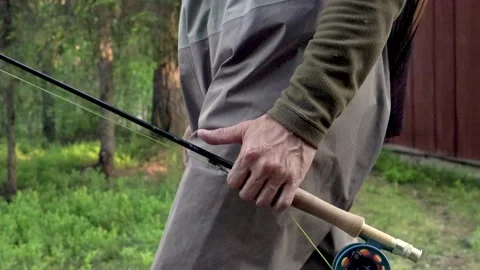 This is a fisherman going to the river to fly-fish Stock Footage 201135691