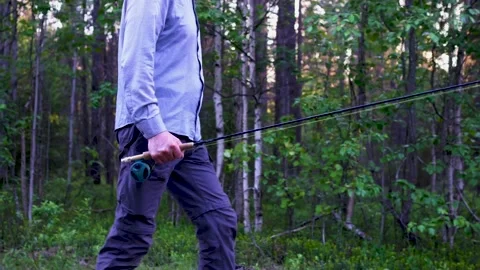 This is a fisherman going to the river to fly-fish Stock Footage 201402864