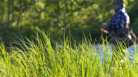 This is a fisherman going to the river to fly-fish Stock Footage 201403632