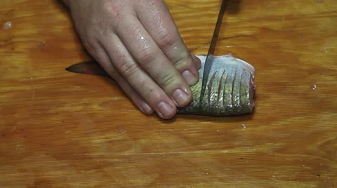 Fisherman hands with knife hacking fish Stock Footage 36004684