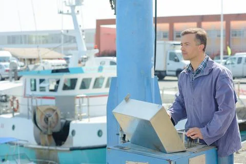 A fisherman at harbor controls Stock Photos
