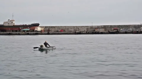 A fisherman in an inflatable boat 動画素材 58900806