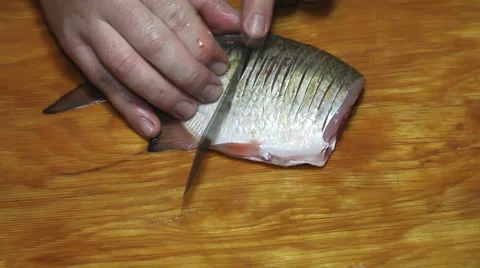 Fisherman with knife hacking fish Stock Footage 36005153