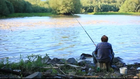 Fisherman by lake Stock Footage 7840146