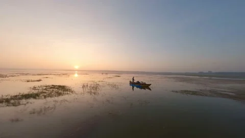 A fisherman on the lake pulls nets at dawn Sri lanka Video stock 224333236