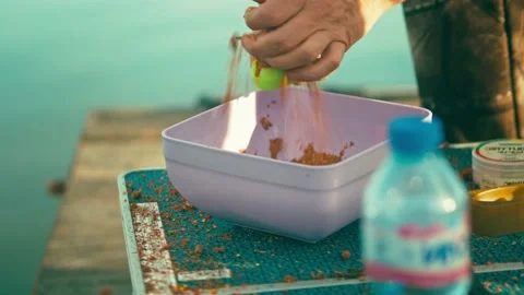 Fisherman loads the bait in the method feeder tackle for fishing. Sport fishing Stock Footage 239661289