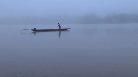 Fisherman in the long tail boat floating in the Mekong river. Stock Footage 71642020