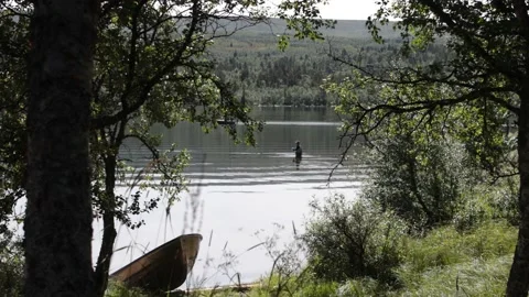 Fisherman in a mountain lake Stock Footage 232326546