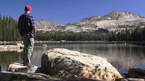 Fisherman on mountain lake, reflection Stock Footage 41691037
