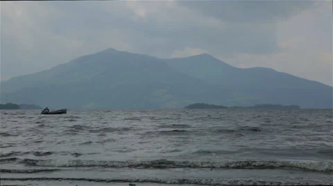 Fisherman on Ocean with Mountains Stock Footage 49507834