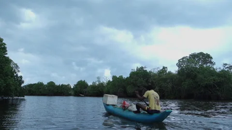 Fisherman paddling on river Video stock 53104581
