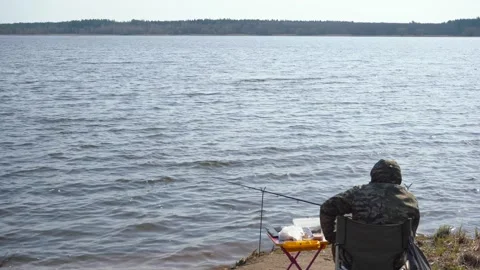 A fisherman on a pond catches fish on spinning Stock-Footage 158952553