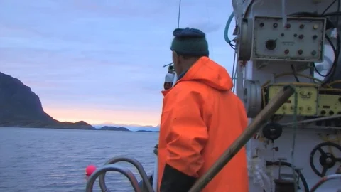 A fisherman preparing for his next task onboard his vessel. Stock Footage 103530639