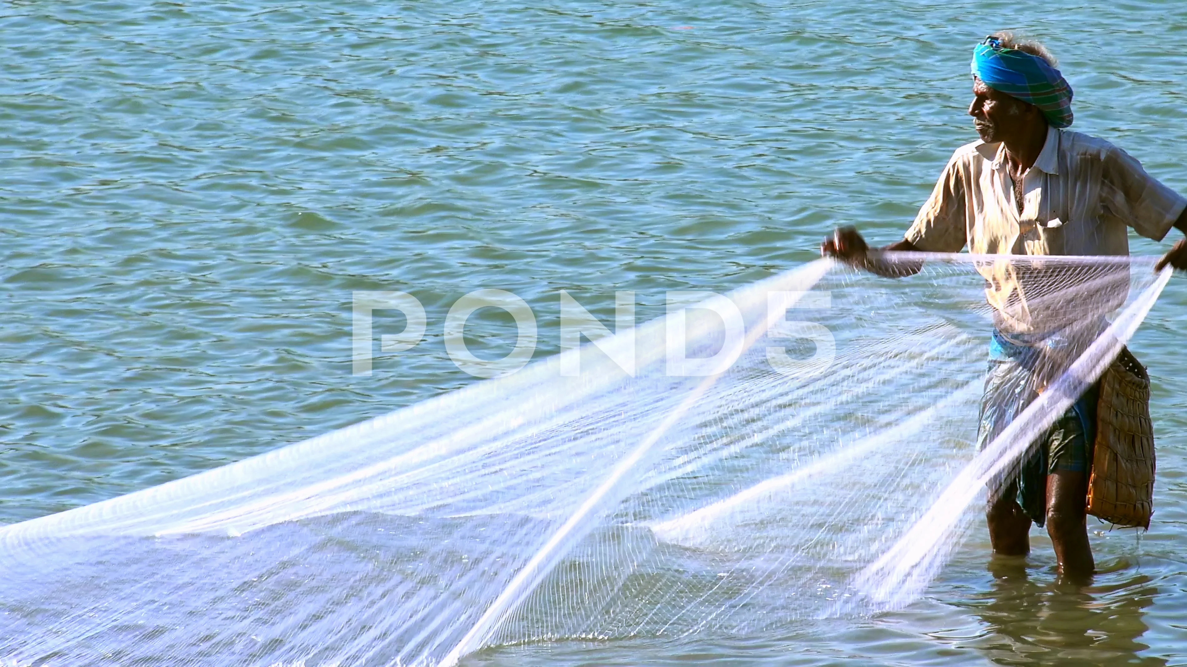 Fisherman pulling fishnet with catch out, Stock Video
