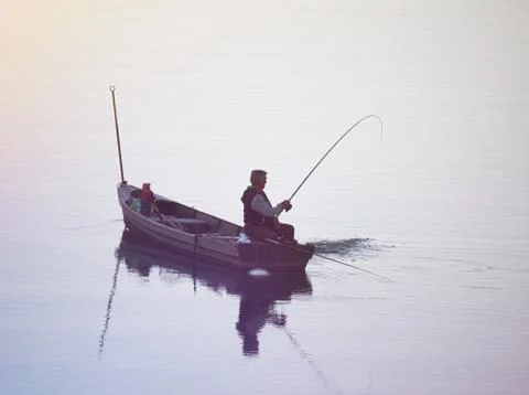 Fisherman Pulling his Catch Stock Photos