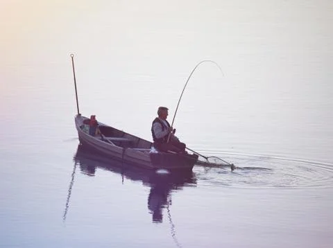 Fisherman Pulling his Catch Stock Photos