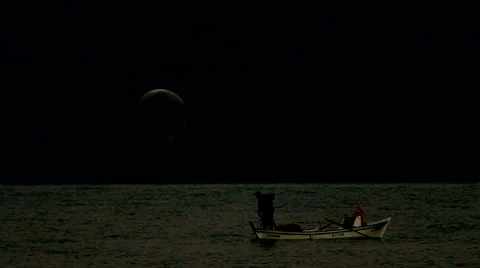 Fisherman pulling in his nets against timelapse full moon Stock Footage 1038630