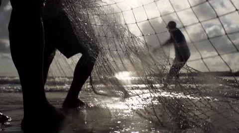 Fisherman pulling net at sea in slowmotion Stock Footage 68084229