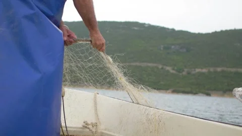 A fisherman pulls an empty fishing net in the Adriatic Sea, Bosnia. Stock Footage 243833564