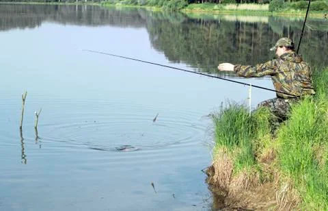 The fisherman pulls the fish ashore Stock Photos
