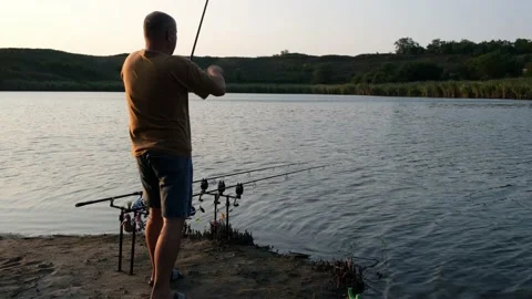 Fisherman pulls the fish out of the river with carp fishing equipment. Angler Video stock 161958318