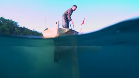 Fisherman Pulls the Net From Underwater Stock Footage 144654107