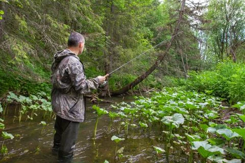 The fisherman pulls out the fish Stock Photos