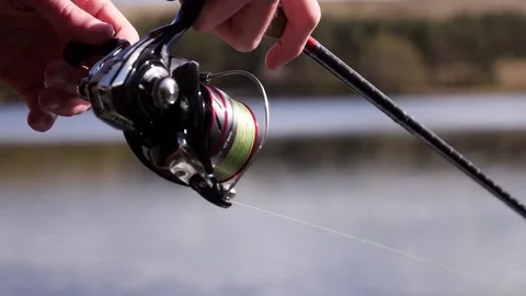 Fisherman reeling in a fish, close up Stock Footage 74604449