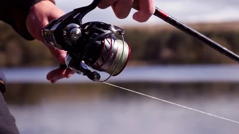 Fisherman reeling in a fish, close up Stock-Footage 74604485