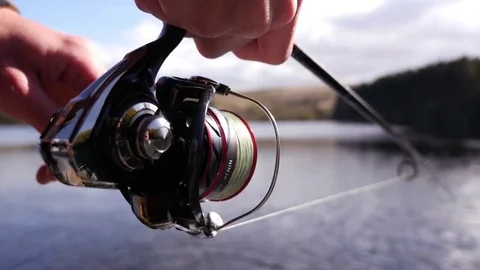Fisherman reeling in a fish Stock Footage 74604553
