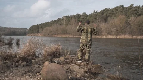 Fisherman on the river prepares to fish Stock Footage 131093391