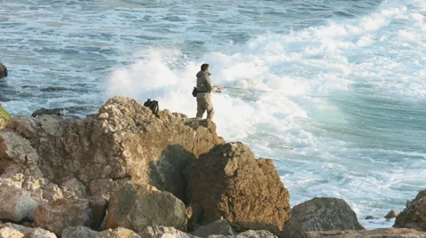 Fisherman on the rock - Tonel beach 動画素材 47014328