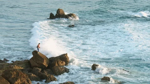 Fisherman on the rock - Tonel beach 動画素材 47014551