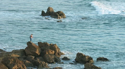 Fisherman on the rock - Tonel beach Stock Footage 47014664
