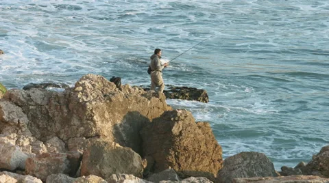 Fisherman on the rock - Tonel beach 動画素材 47014923