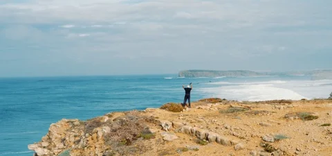Fisherman on sandy cliff Stock Footage 123253857