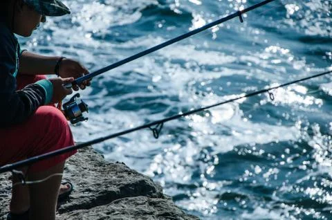 Fisherman on the seashore Stock Photos