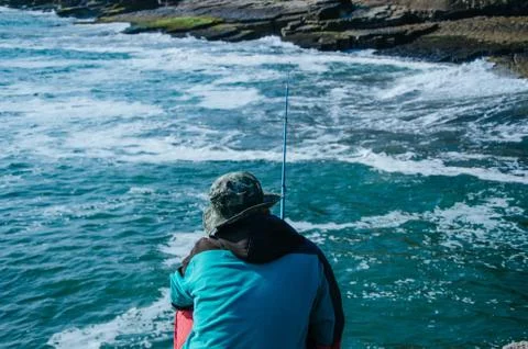 Fisherman on the seashore Stock Photos