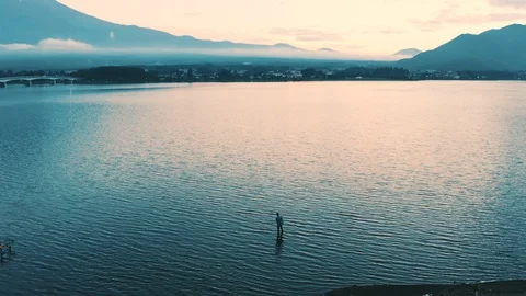 Fisherman in the shadow of Mt Fuji Video stock 123221961