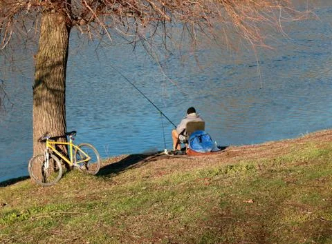 The fisherman sits by the river Stock Photos