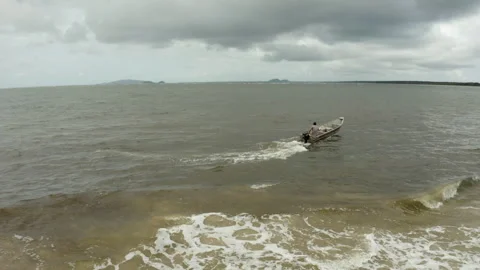 Fisherman in Small Boat Crossing Waves Stock Footage 340521963