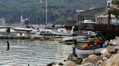 Fisherman in small harbor at sundown 스톡 동영상 731015