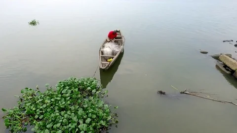 Fisherman sorting out his net in pirogue Stock Footage 80954274