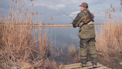 Fisherman spinning fish on the river Stock Footage 128655894