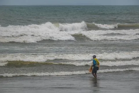 Fisherman Standing in Ocean Waves with Net Stock-Fotos