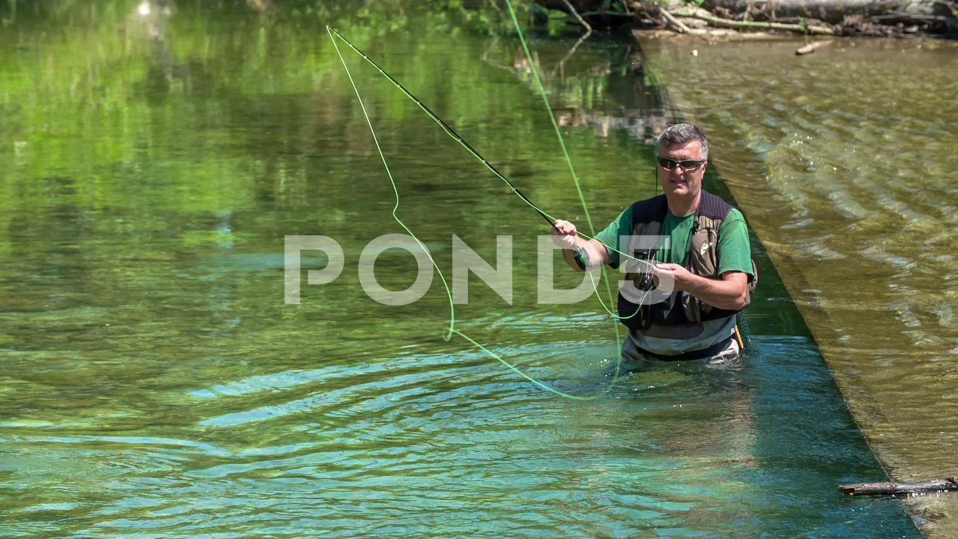 Fisherman is standing in the water and t, Stock Video