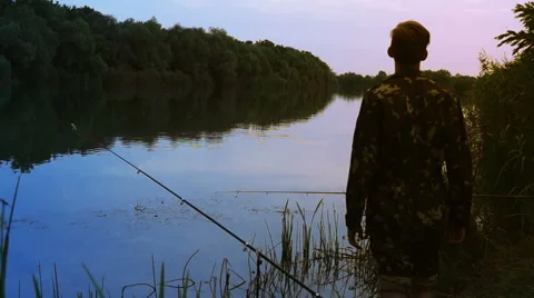 Fisherman Stands on the Riverside. Stock Footage 55516602