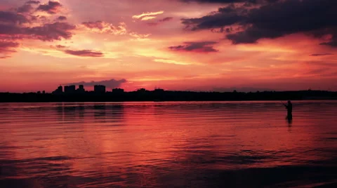 Fisherman at Sunset above the River Stock Footage 63032830