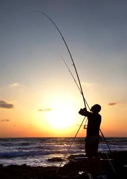 Fisherman at sunset Photos